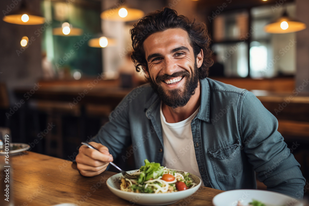 Generated with AI picture of handsome cheerful man in cafe eating tasty vegetables salad Generated with AI picture of handsome cheerful man in cafe eating tasty vegetables salad