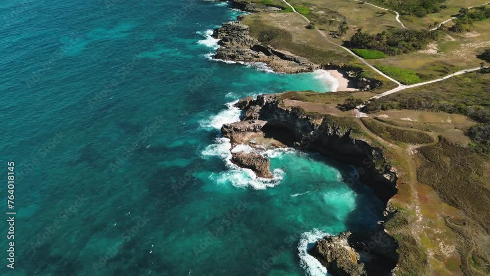 Area view of Colorful waters of the ocean, swirl around the rocky and scenic coastline. Sea waves breaking over rocks. Area view of Colorful waters of the ocean, swirl around the rocky and scenic coastline. Sea waves breaking over rocks.