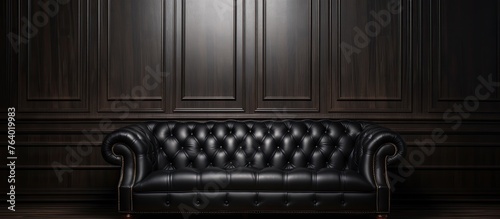 A scene depicting a black leather couch situated in a dimly lit room with wooden panel walls © TheWaterMeloonProjec