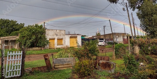 Big rainbow under poor city