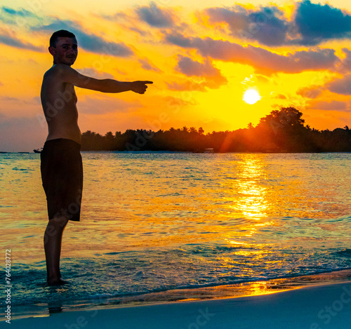 Kuramathi Maldives tropical paradise island sunset man handsome male tourist. photo