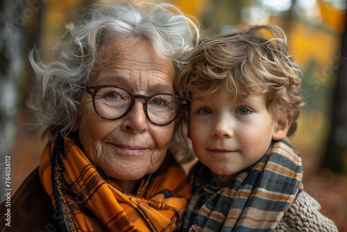 Evocative portrait of a grandmother and grandson in an autumnal setting, filled with warmth