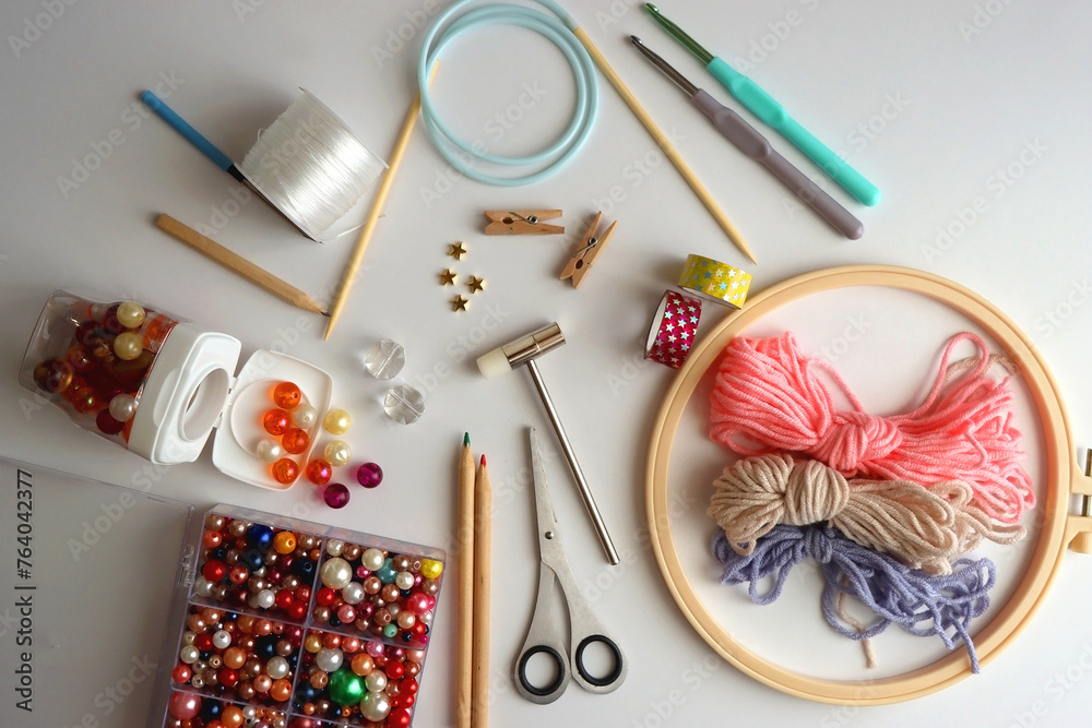 Various craft supplies on white background. Supplies for jewelry making, drawing and needlework. Flat lay. Various craft supplies on white background. Supplies for jewelry making, drawing and needlework. Flat lay.