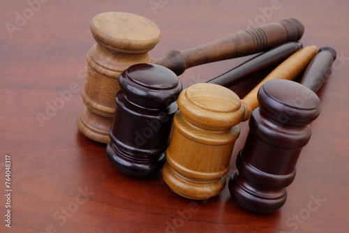 Different wooden judge gavels on table close-up. Courts decisions and legal systems concept.