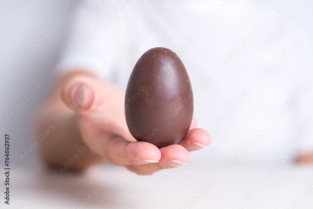 close up of hands holding an easter egg, holy week, religious celebration close up of hands holding an easter egg, holy week, religious celebration