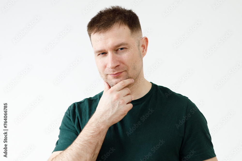 A man in a green T-shirt shows emotions in front of the camera A man in a green T-shirt shows emotions in front of the camera