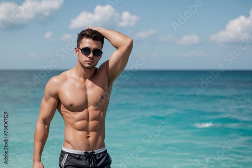 Shirtless man in sunglasses and swimming trunks standing on the sea with copy space.