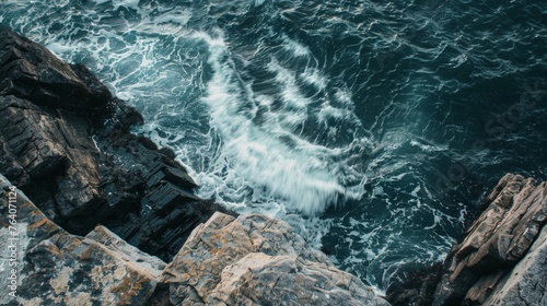 Aerial view of waves crashing on rocky shoreline
