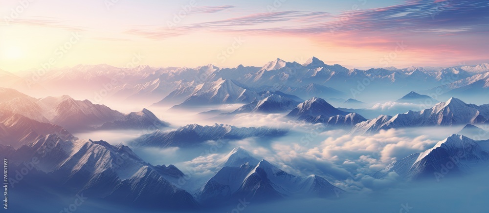 A scenic view of mountains covered in clouds with a beautiful sunset in the background
