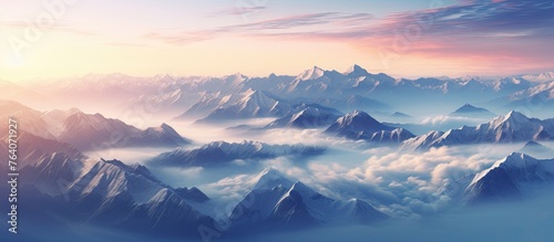 A scenic view of mountains covered in clouds with a beautiful sunset in the background