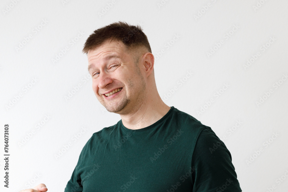A man in a green T-shirt shows emotions in front of the camera A man in a green T-shirt shows emotions in front of the camera