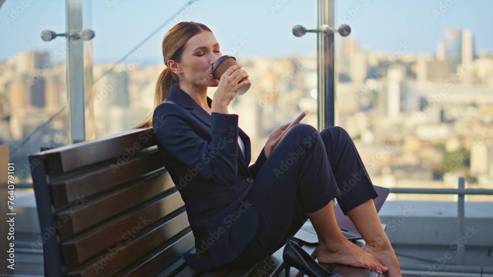 Calm worker sipping coffee resting morning terrace. Peaceful woman check mobile - obrazy, fototapety, plakaty 