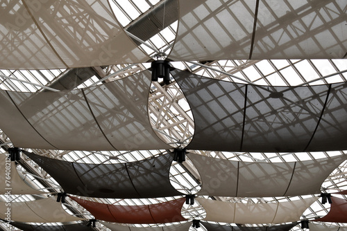 Interior View of Sun Shades Suspended from Glass and Steel Roof of Modern Industrial Building