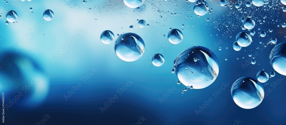 A close up of water droplets floating on top of a vibrant blue surface