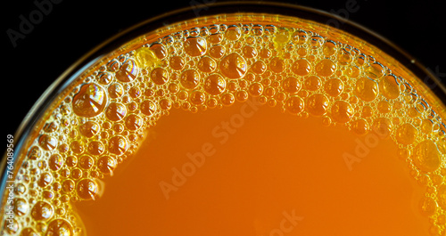 Macro orange juice texture,Diet healthy nutrition. Fresh yellow fruits juice background texture. Orange water bubbles. Macro