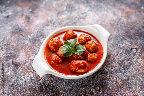 Chicken meatballs with tomato sauce.