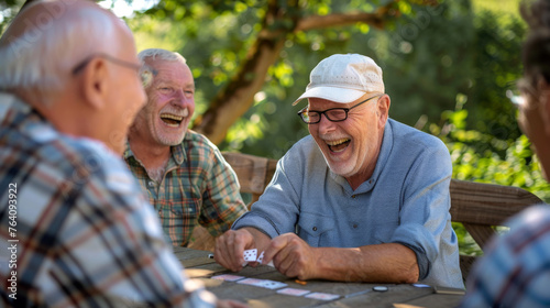 Senior men with smiles engage in a card game outdoors.
