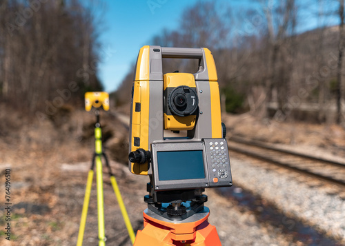 land surveying total station instrument on a tripod in the field
