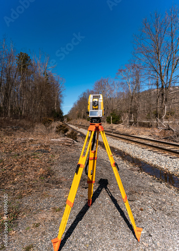 land surveying total station instrument on a tripod in the field