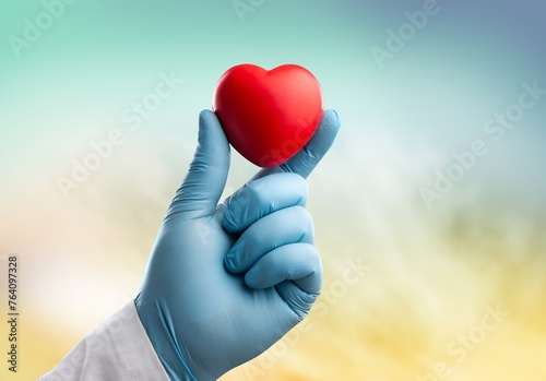 Hands of human doctor holding heart symbol