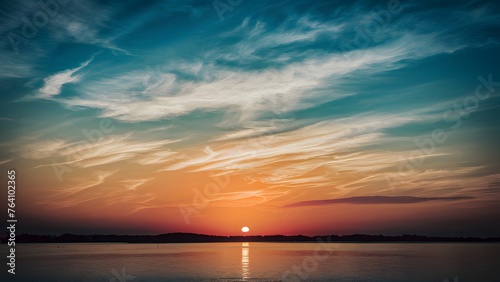 Sun sets over a tranquil blue sky dotted with wispy clouds