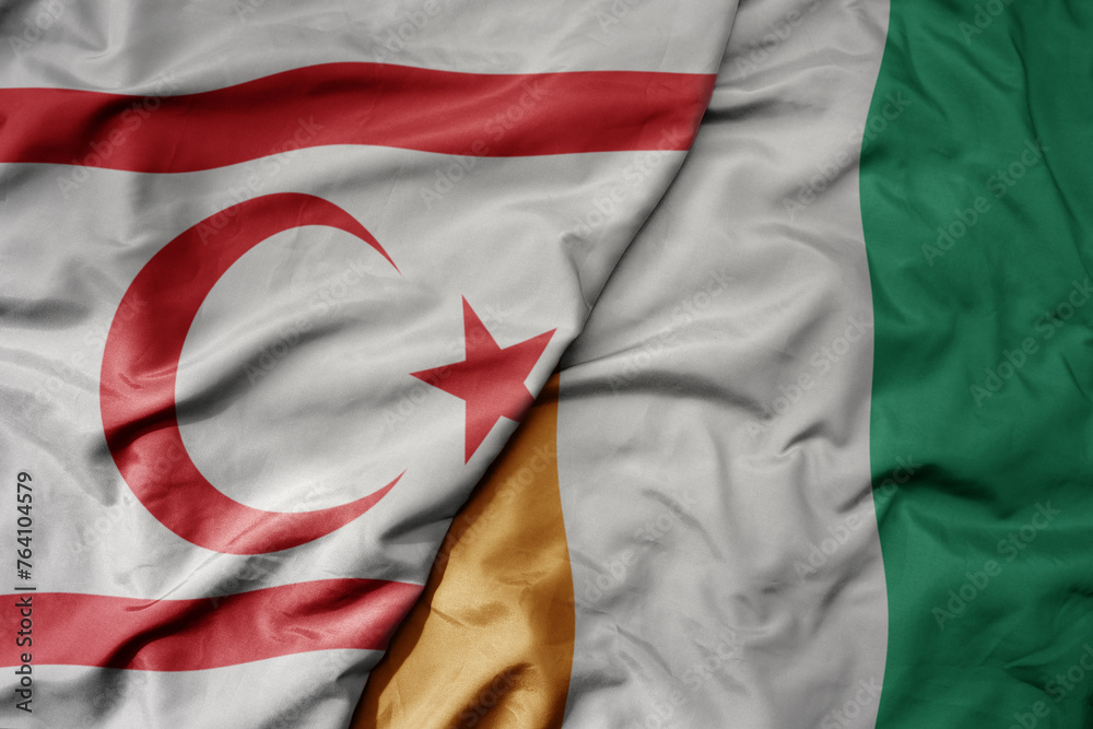 Obraz premium big waving national colorful flag of cote divoire and national flag of northern cyprus.
