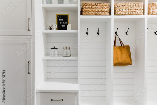 Shelving and organization with baskets and hooks and cabinets. photo