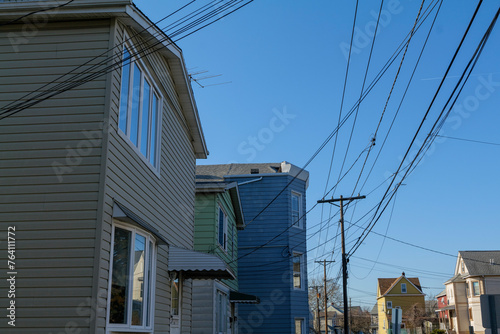Old residential houses in a row in Wallington New Jersey, wires hanging from poles. High-quality photo