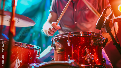 Drummer playing drum sticks on a snare drum, close up.