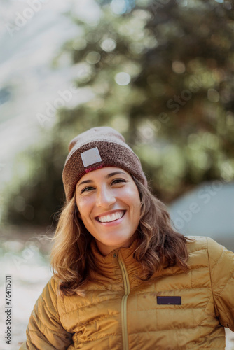 Smiling woman in winter hat and jacket outdoors