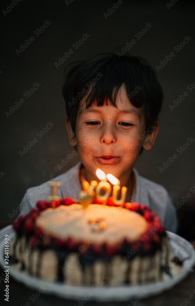 child with birthday cake