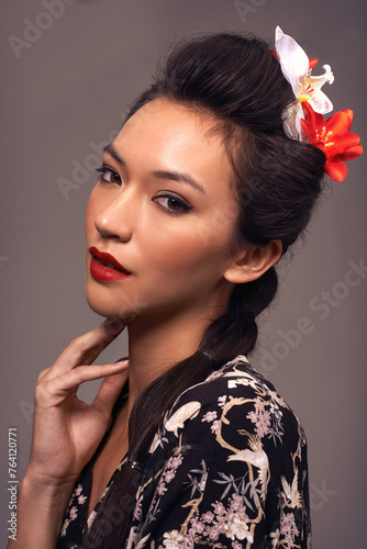 Japanese woman  portrait and culture in studio  beauty and traditional aesthetic on brown background. Female person  cosmetics and self care for dermatology  heritage and attitude for serious makeup