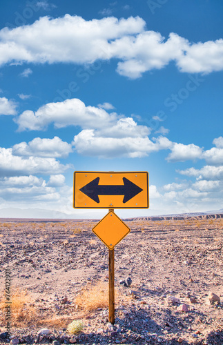 Direction sign in the desert under a blue sky. Concept of uncertain, risk, choice, decision