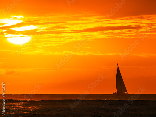 sailboat with a maui sunset in the background