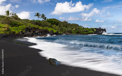 Black sand beach in Maui with ocean