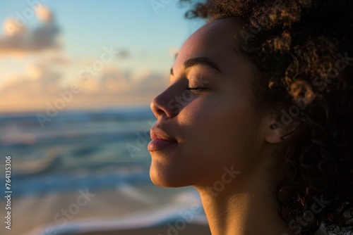 Young woman enjoying the serene sunset by the beach