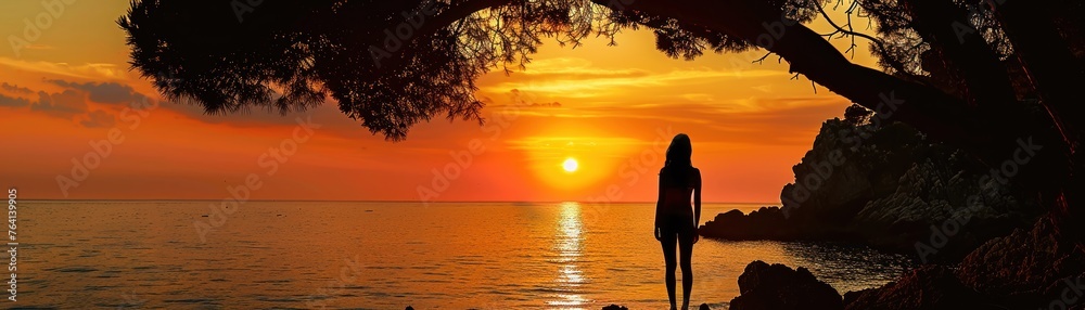 A Silhouette of a woman at sunset majestic sea cliffs and trees