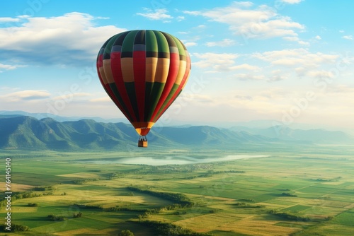 Aerial view of hot air balloon drifting above verdant fields with ample copy space