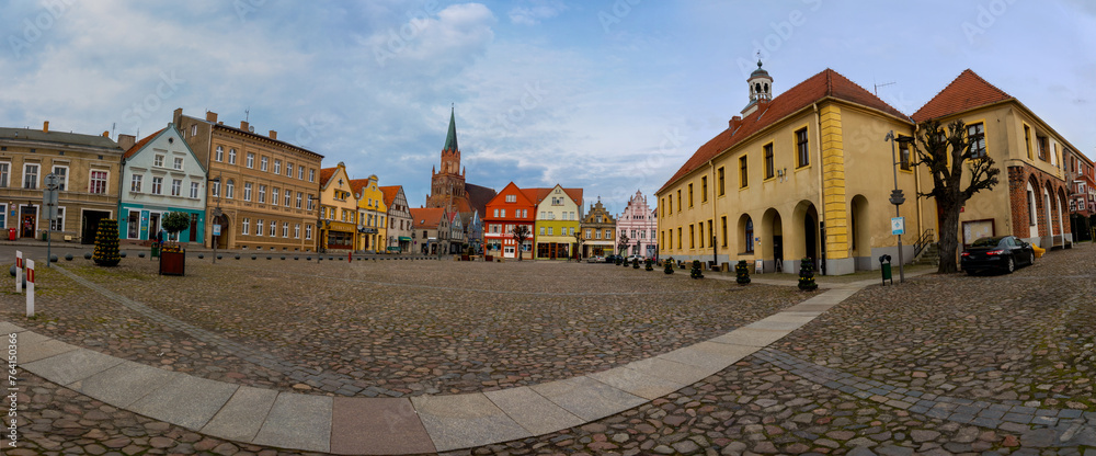 Obraz premium Panoramic view of old market square with town hall and gothic church of St. Mary in Trzebiatow, Poland