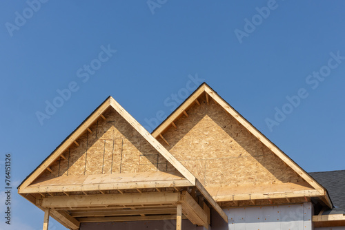Dormers of a residential construction project showing plywood roof and oriented strand board or chip board dormer sheathing