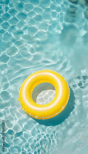 Yellow inflatable ring on clear beautiful water. Summer time concept. Template, copy space, rest, vacation.