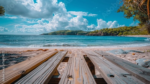 Breathtaking view of a pristine beach from the perspective of weathered wooden planks