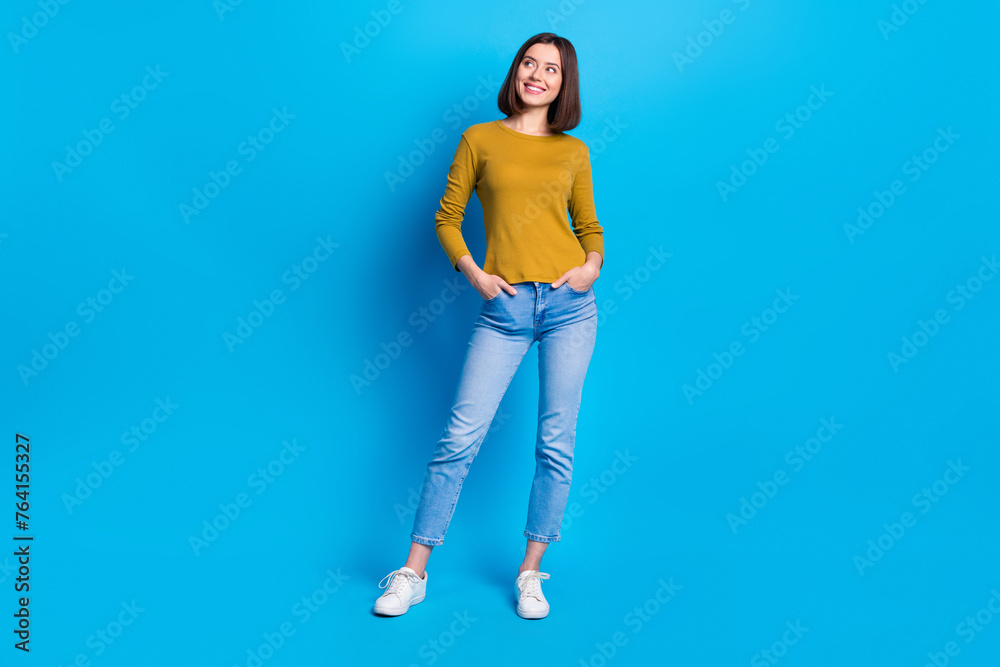 Full length photo of thoughtful dreamy lady dressed shirt smiling looking empty space isolated blue color background Full length photo of thoughtful dreamy lady dressed shirt smiling looking empty space isolated blue color background