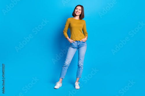 Full length photo of thoughtful dreamy lady dressed shirt smiling looking empty space isolated blue color background