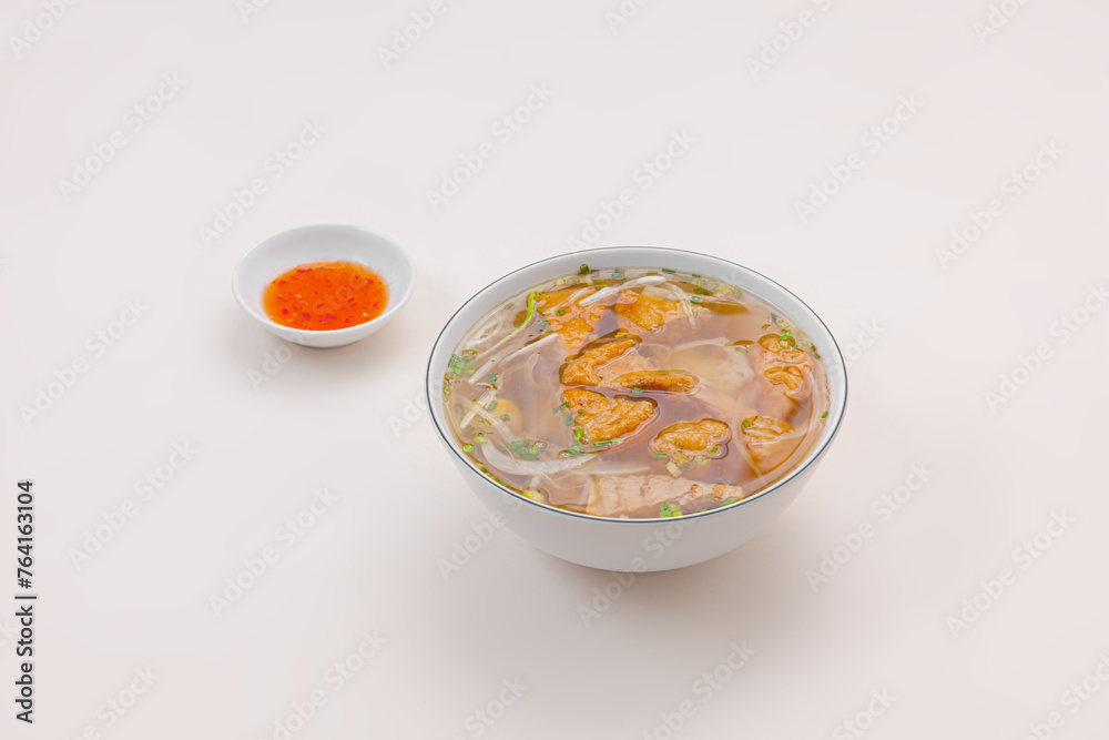 Banh canh cha ca Nha Trang, Rice noodles soup with fish cake from Nha Trang , Vietnamese food isolated on white background, perspective view Banh canh cha ca Nha Trang, Rice noodles soup with fish cake from Nha Trang , Vietnamese food isolated on white background, perspective view