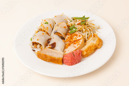 Banh Cuon, Vietnamese steamed rice rolls pancake with savory mixture of ground pork, Vietnamese food isolated on white background, close-up photo