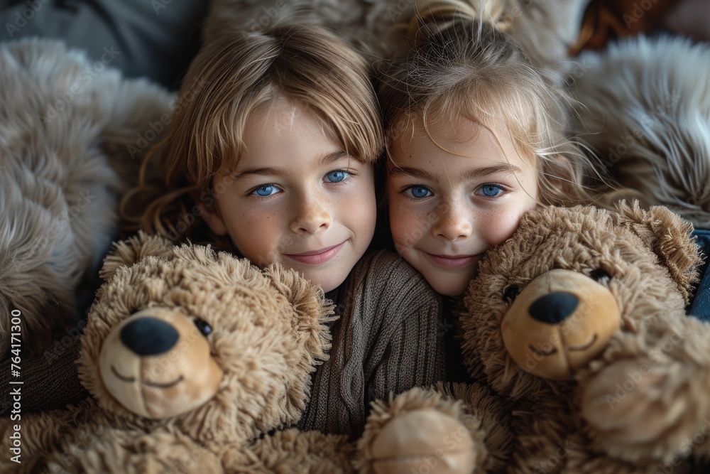 Twin sisters with strikingly similar faces smile gently, lying together with teddy bears Twin sisters with strikingly similar faces smile gently, lying together with teddy bears