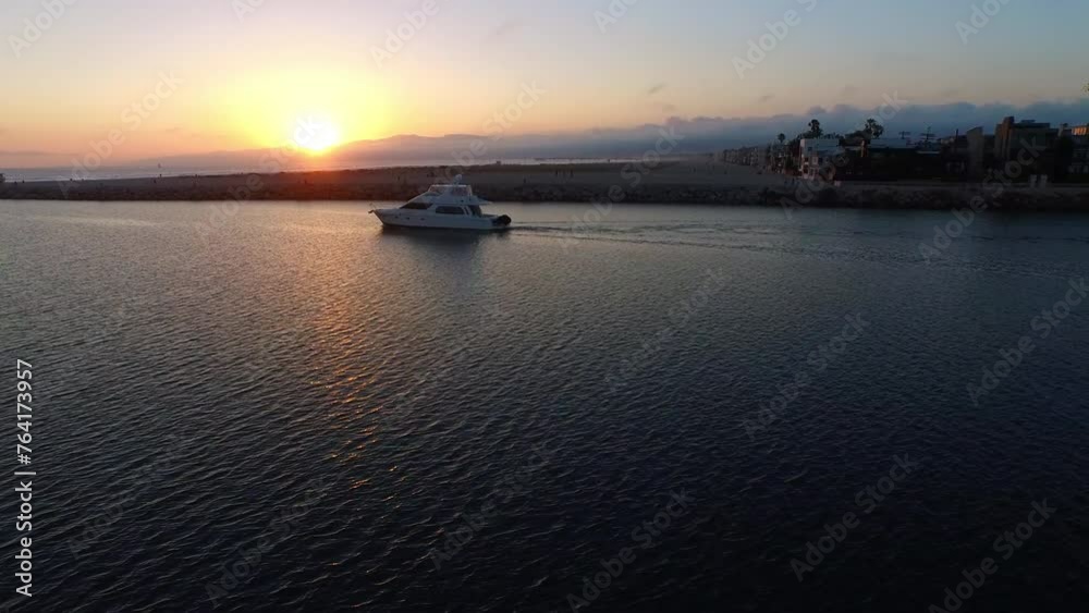 Aerial: Drone Forward Shot Of Motorboat Moving In Rippled Ocean During Tranquil Sunset - Marina del Rey, California Aerial: Drone Forward Shot Of Motorboat Moving In Rippled Ocean During Tranquil Sunset - Marina del Rey, California