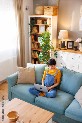 Female freelancer using laptop computer while working from home
