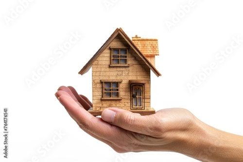 Human hand holds a miniature house or home model, new house, property insurance.